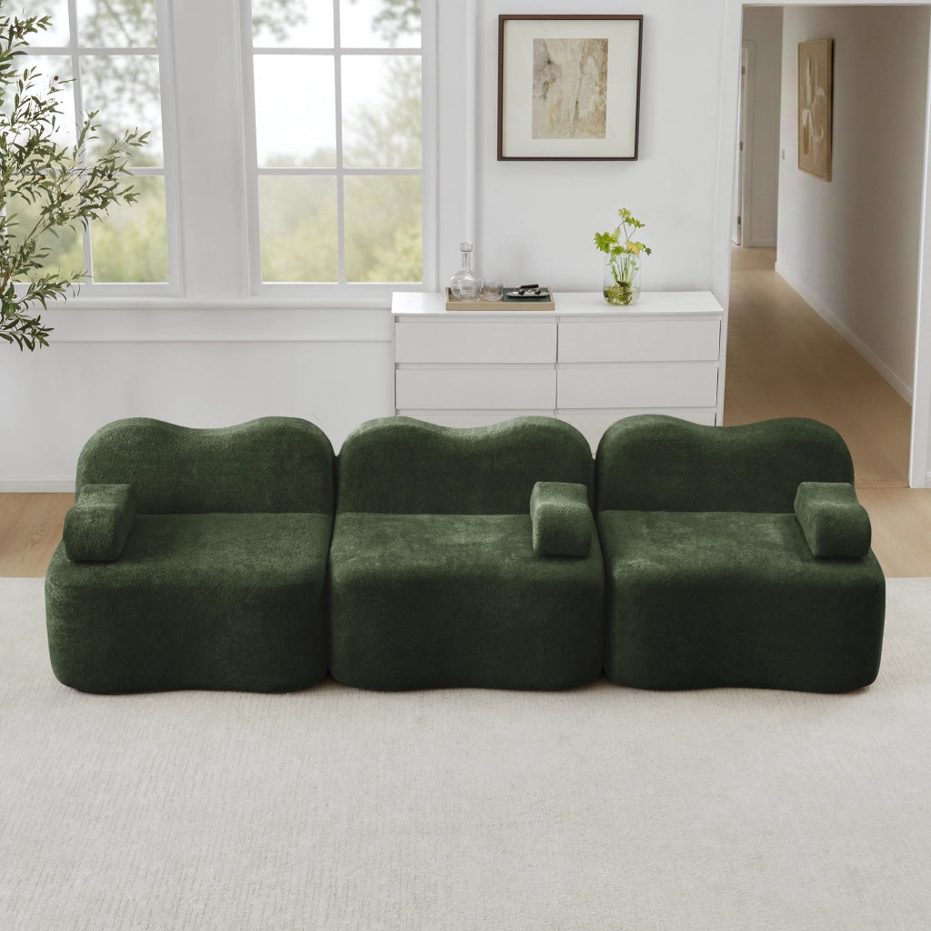 Divano angolare modulare senza struttura interna in velluto verde con seduta profonda e pouf collegabile ondulato