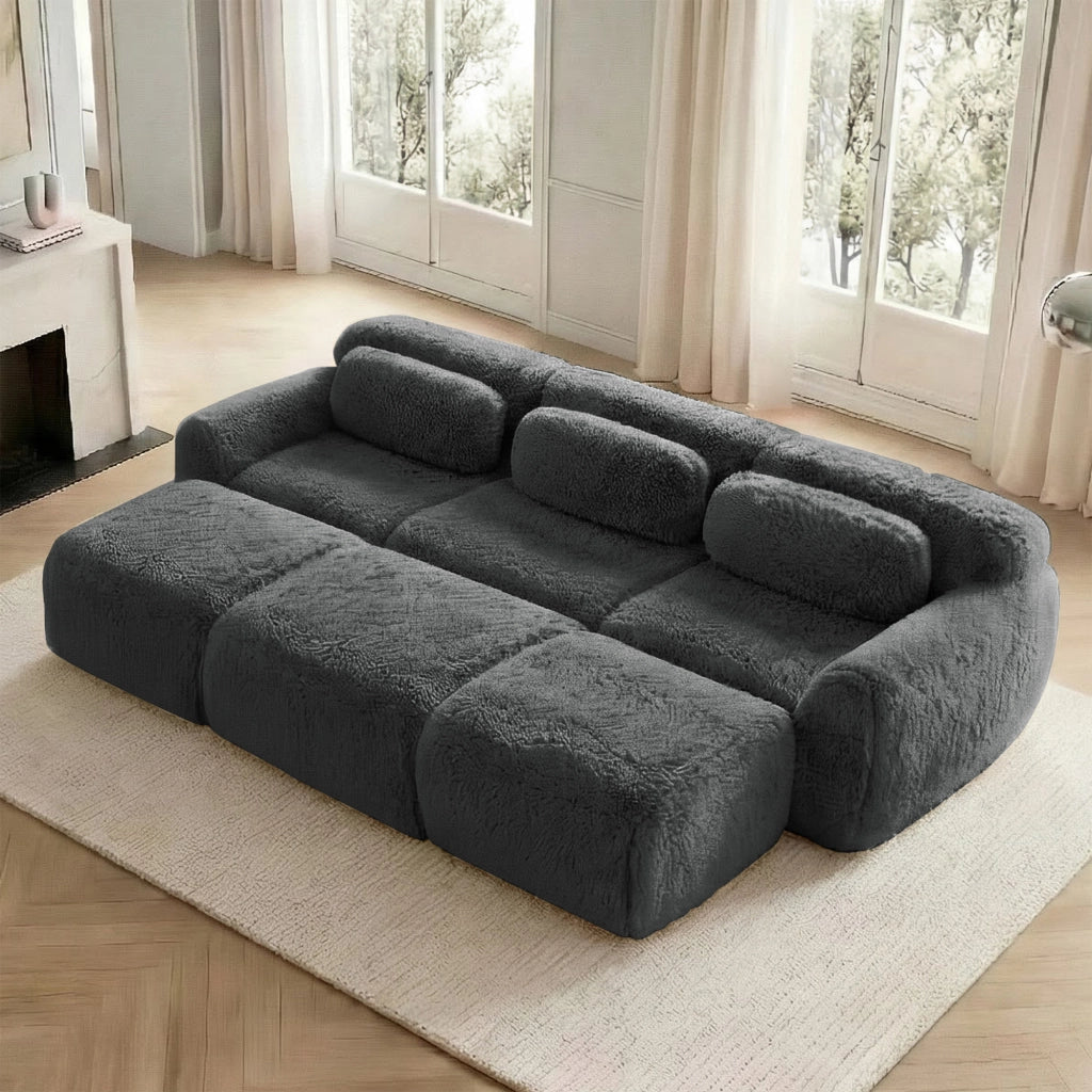 Divano modulare 3 posti in tessuto plush grigio con ottomana collegabile schienale curvo base antiscivolo