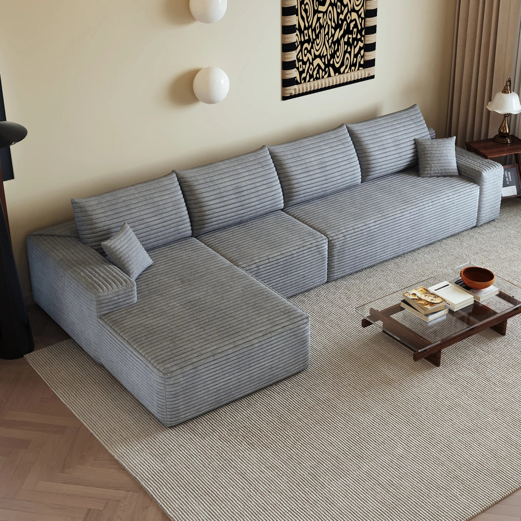 Divano angolare modulare con chaise longue e seduta profonda, pronto all'uso in tessuto a coste grigio