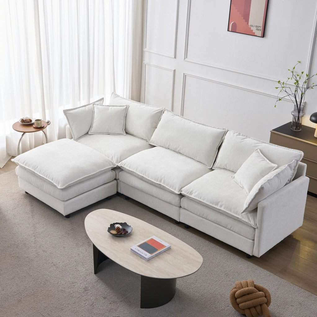 Divano angolare modulare a L 3 posti con chaise longue e pouf in tessuto chenille premium