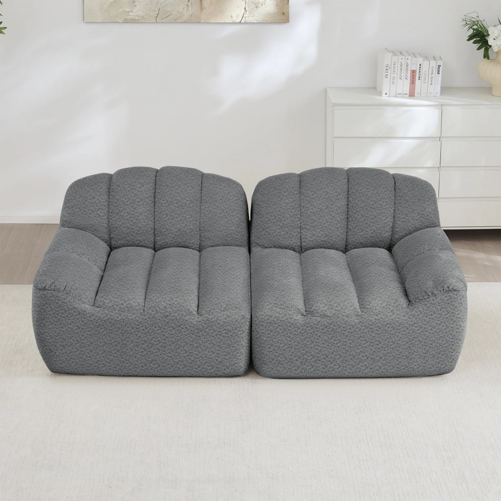 Divano modulare senza montaggio con seduta ampia e schienale ergonomico; rivestimento grigio in pile granulato