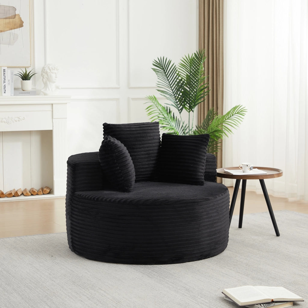 Poltrona lounge rotonda imbottita in velluto a coste nero con 3 cuscini; braccioli larghi e diametro 110 cm