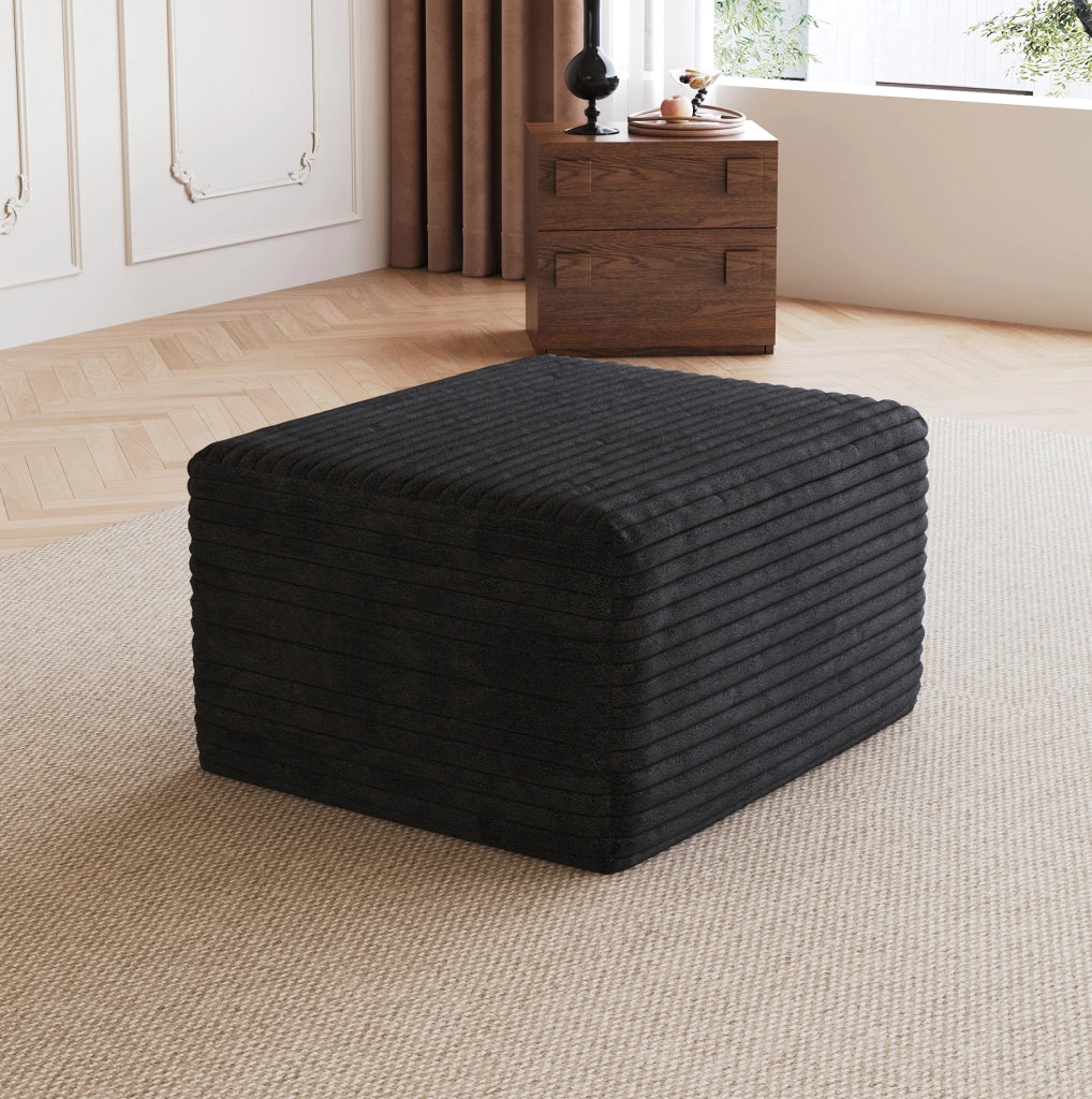 Pouf in tessuto nero senza montaggio