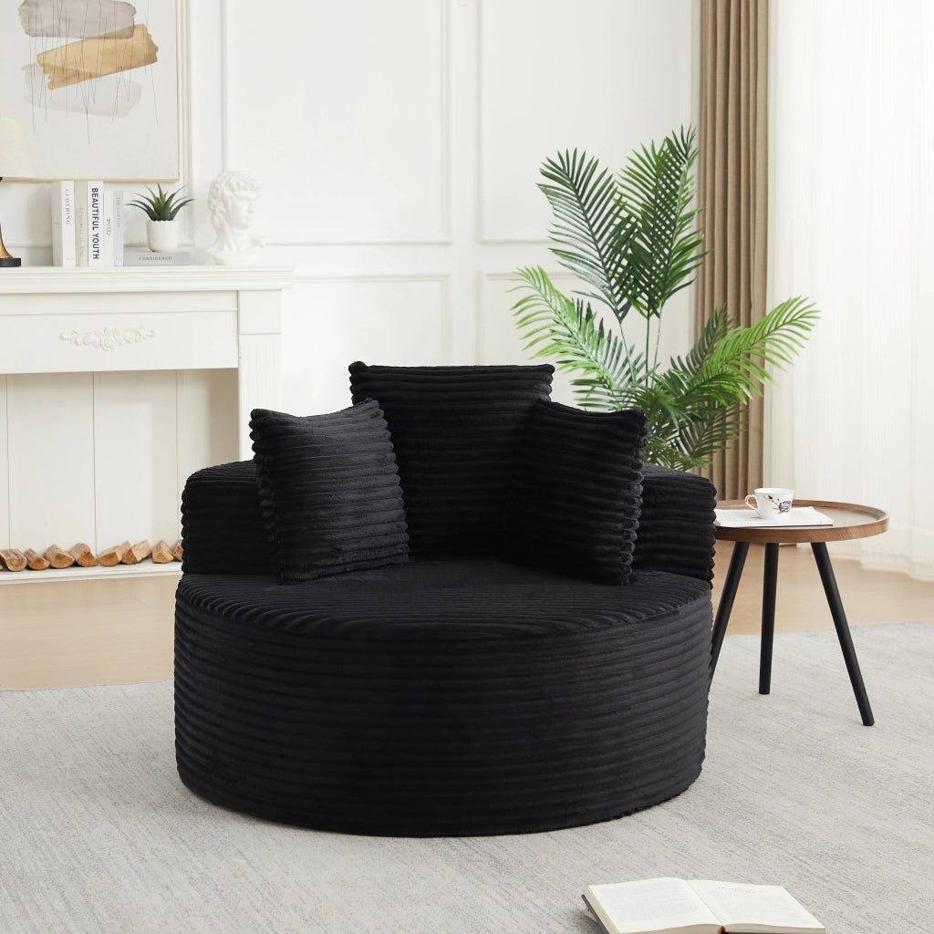 Poltrona lounge rotonda imbottita in velluto a coste nero con 3 cuscini; braccioli larghi e diametro 110 cm