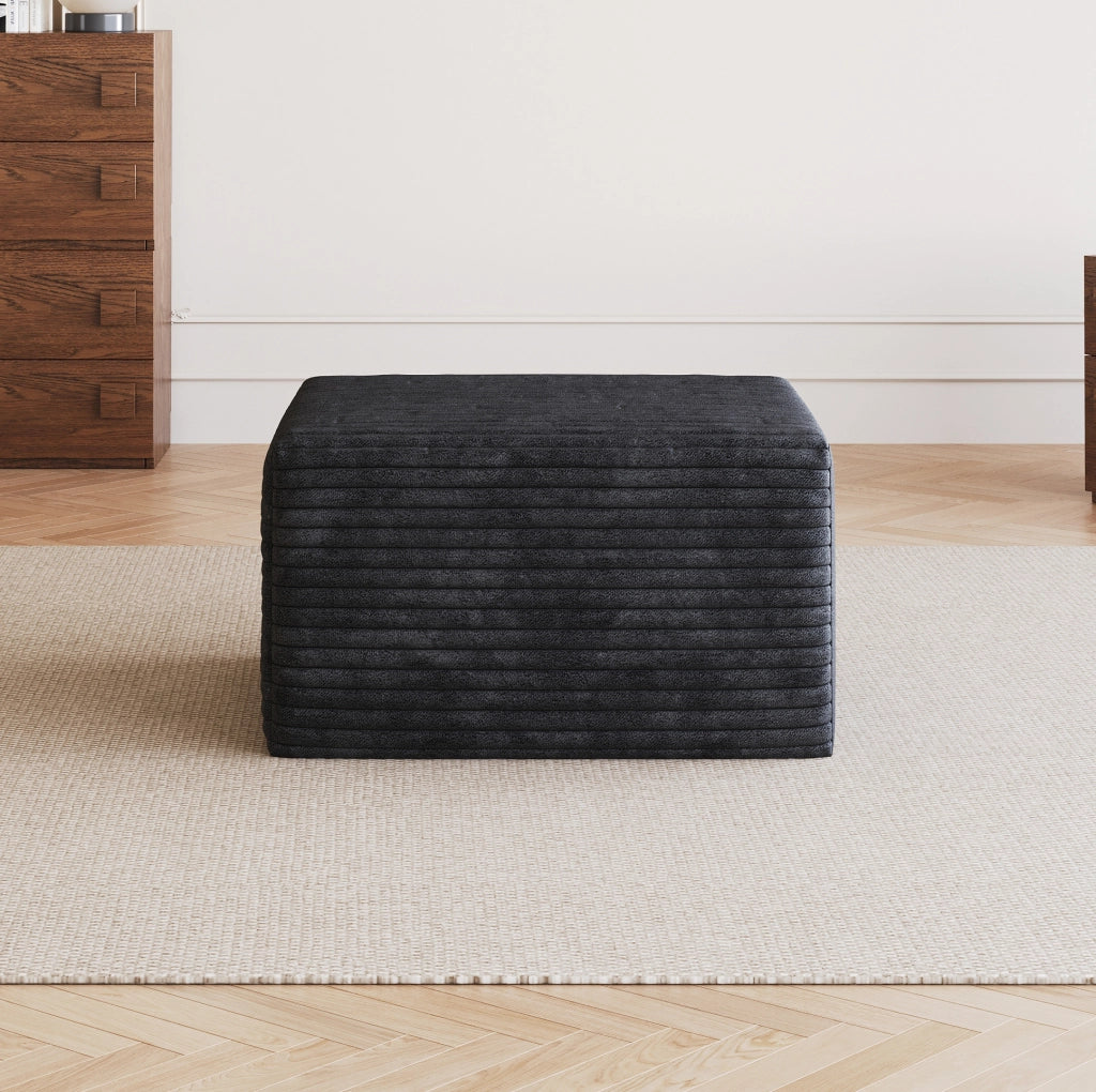 Pouf in tessuto nero senza montaggio