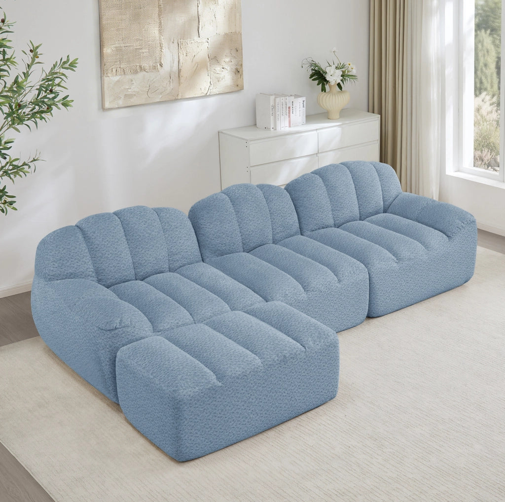 Divano angolare modulare 3 posti con ottomana in pile granulato blu HOMVRA