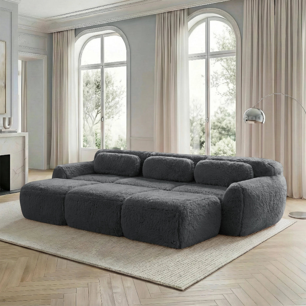 Divano modulare 3 posti in tessuto plush grigio con ottomana collegabile schienale curvo base antiscivolo