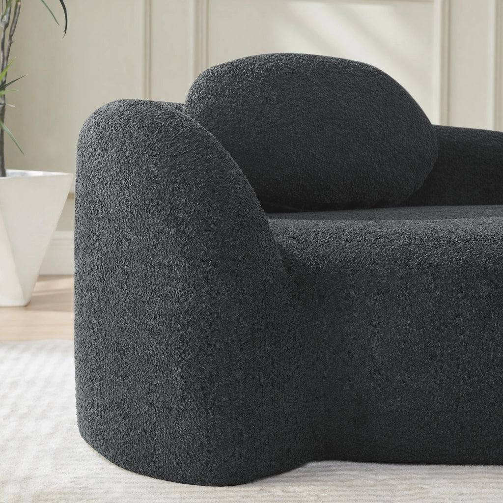 Divano compatto dal design arrotondato in tessuto teddy nero con cuscino