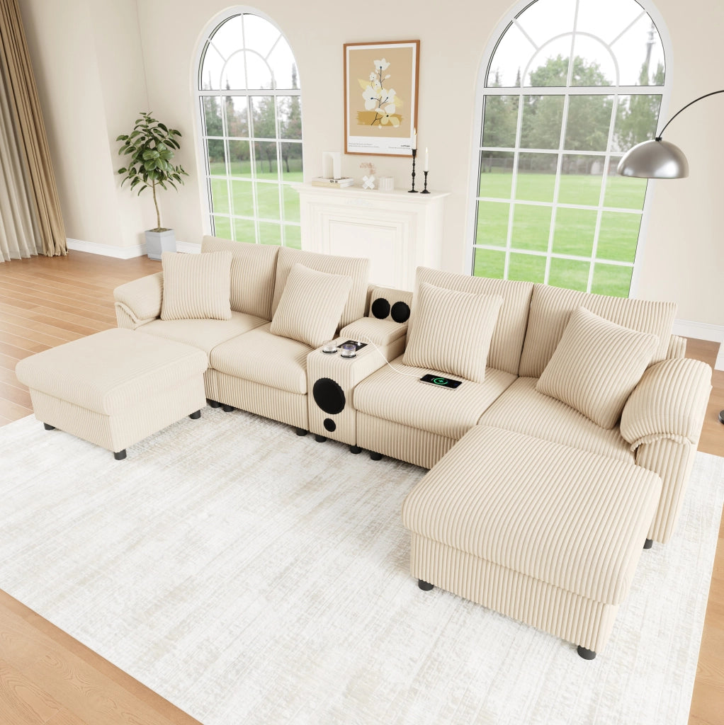 Divano modulare U/L in velluto a coste beige con console Bluetooth; ricarica wireless; USB e Type-C