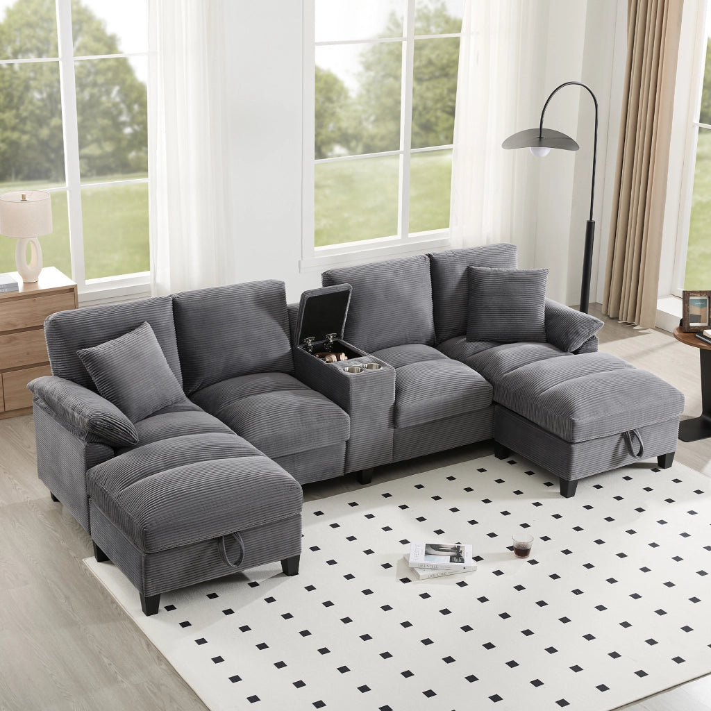Divano a forma di U 4 sedili 293 x 142 x 93 cm; cassettiera porta - tazze; porte 2 USB; cuscini; velluto a coste; grigio