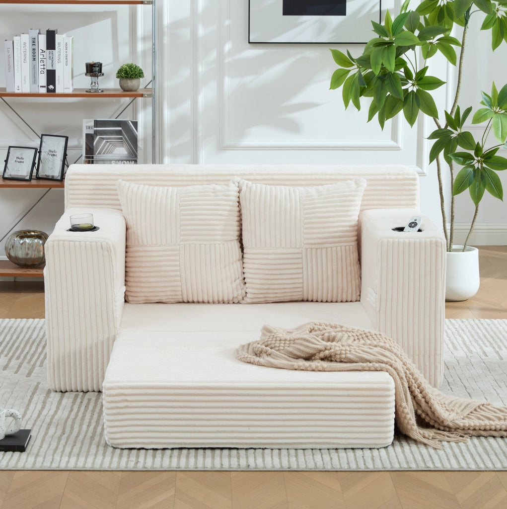 Divano pouf ULEVR in velluto a coste beige con 2 cuscini, braccioli, tasche laterali e poggiapiedi