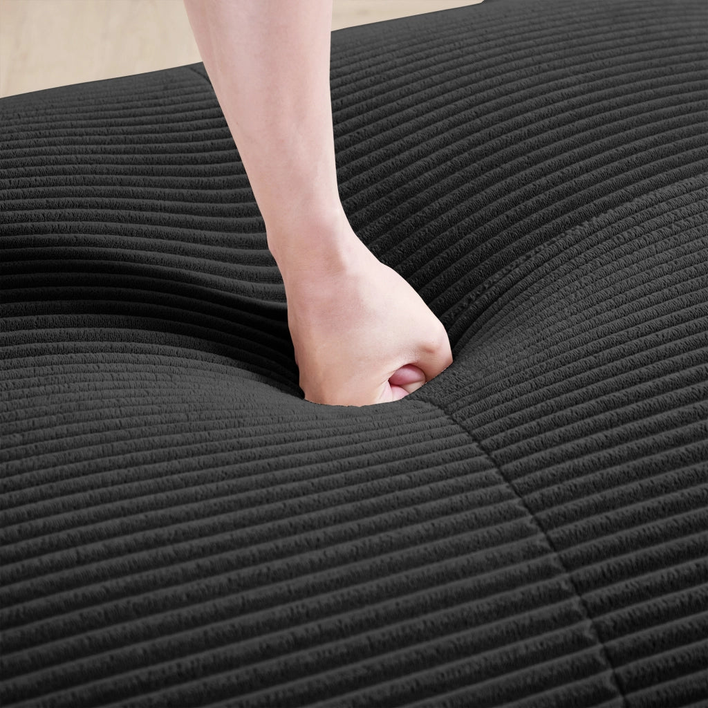 Divano angolare modulare con braccioli ergonomici, imbottito e con base antiscivolo in velluto a coste nero