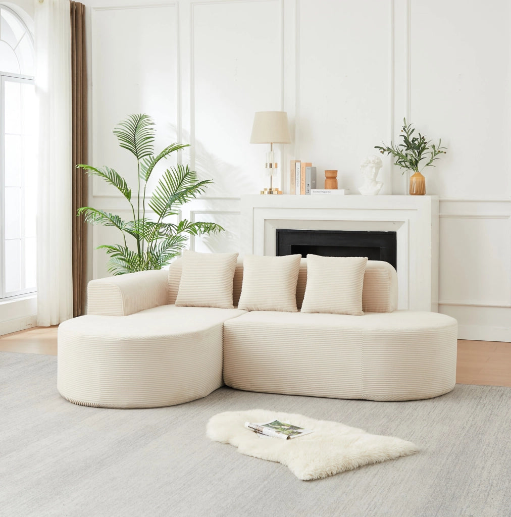Divano modulare a L beige in velluto a coste con forme curve