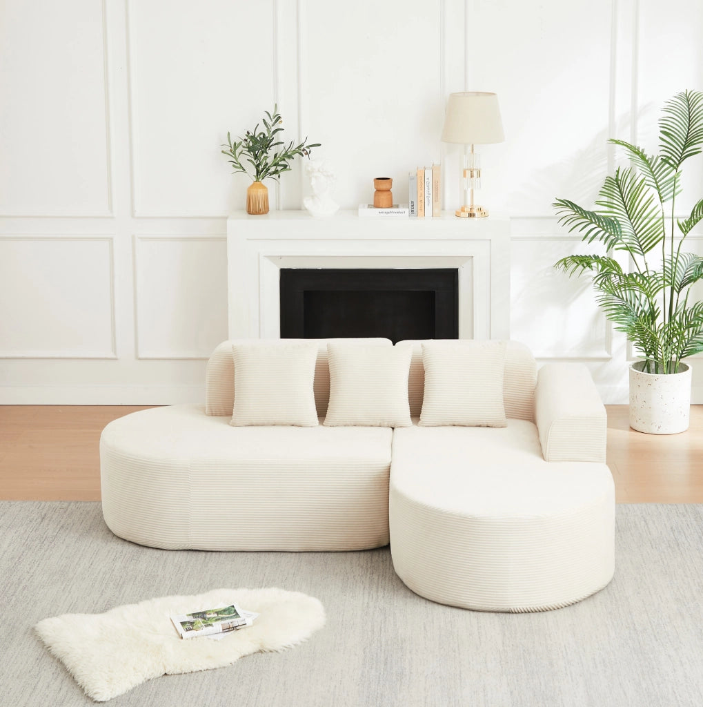 Divano modulare a L beige in velluto a coste con forme curve