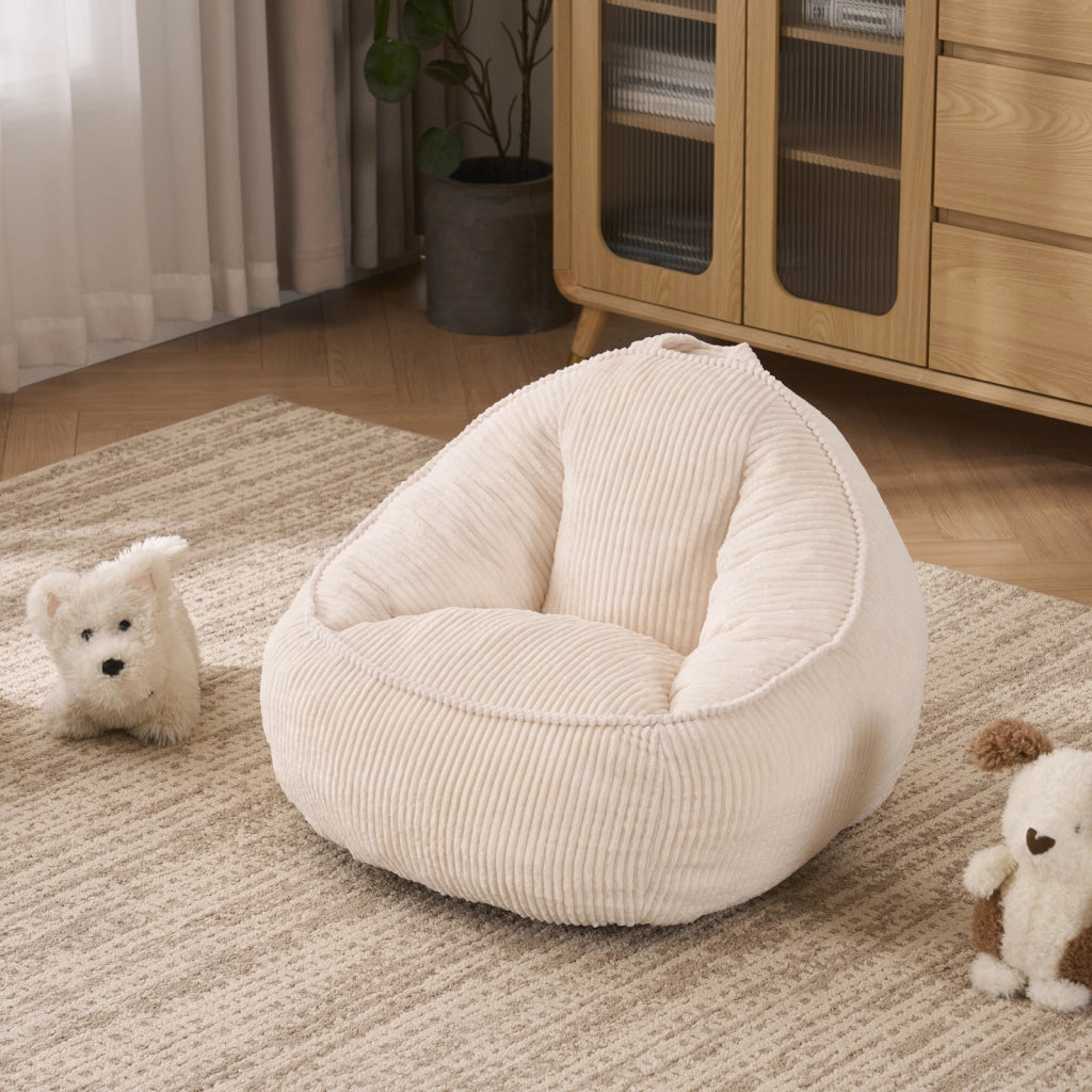 Pouf per bambini in velluto a coste beige con forma curva ergonomica per gioco lettura e relax