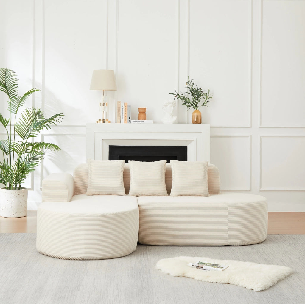 Divano modulare a L beige in velluto a coste con forme curve