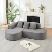 Divano modulare a L grigio in velluto a coste con forme curve