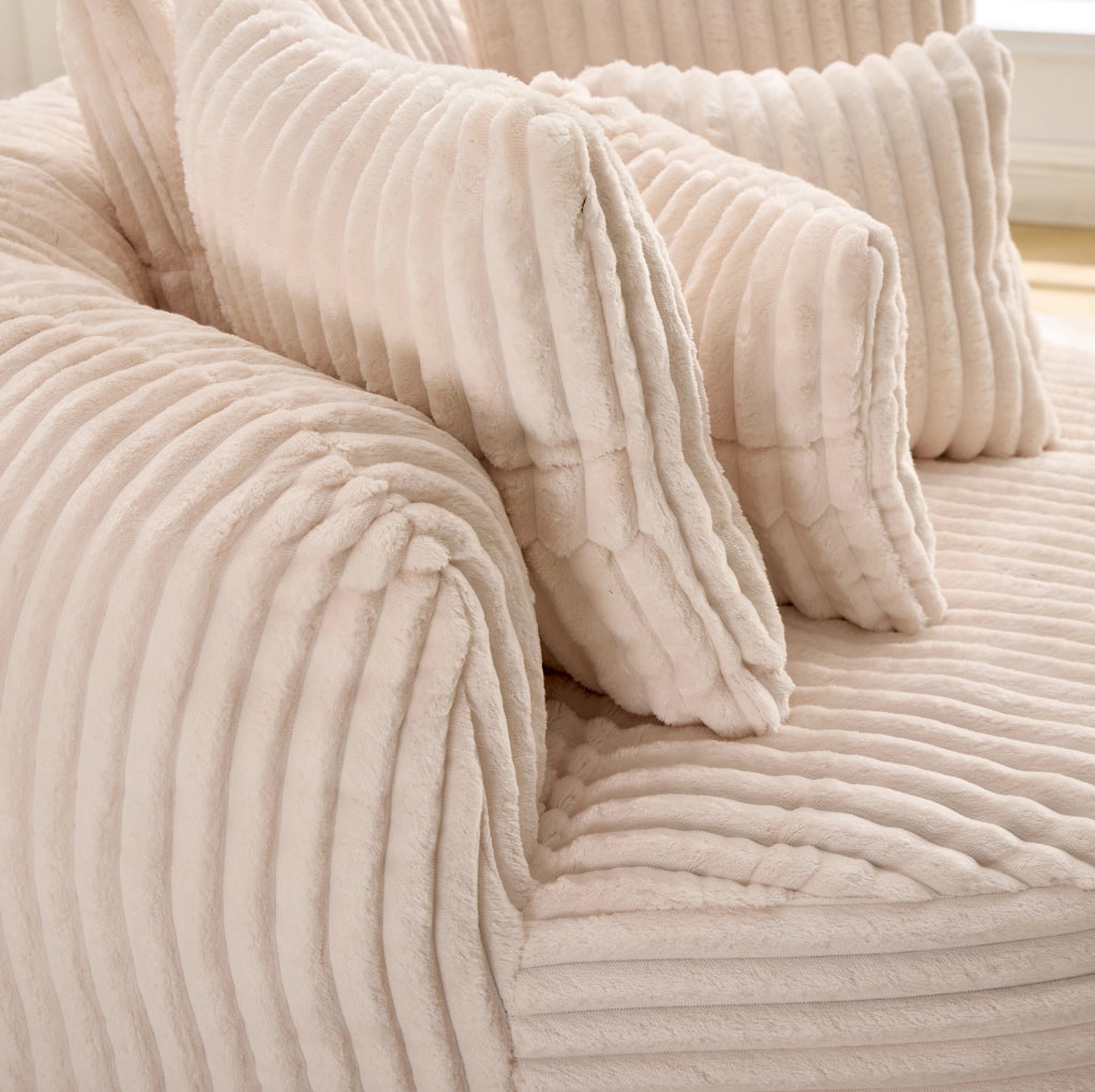 Poltrona rotonda in velluto a coste beige con poggiapiedi e 5 cuscini