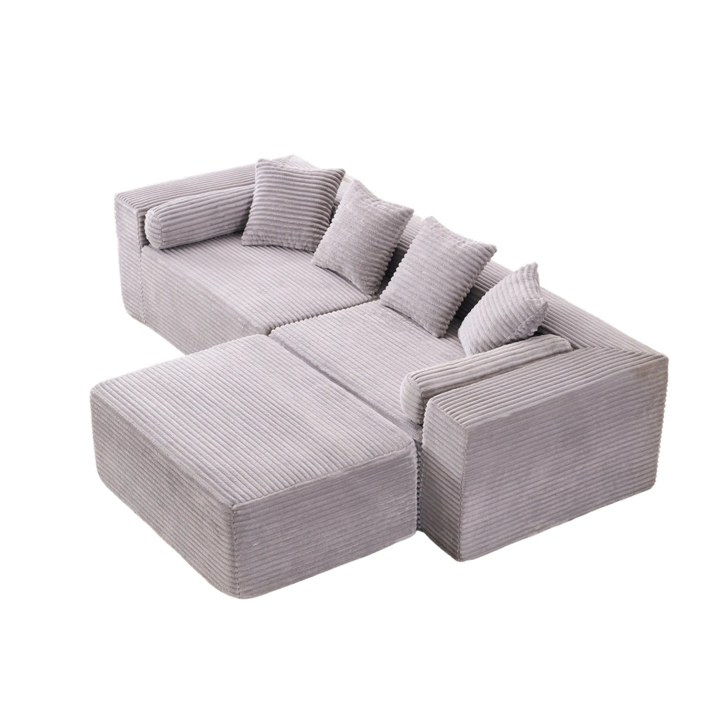 Divano componibile grigio a tre moduli con chaise longue