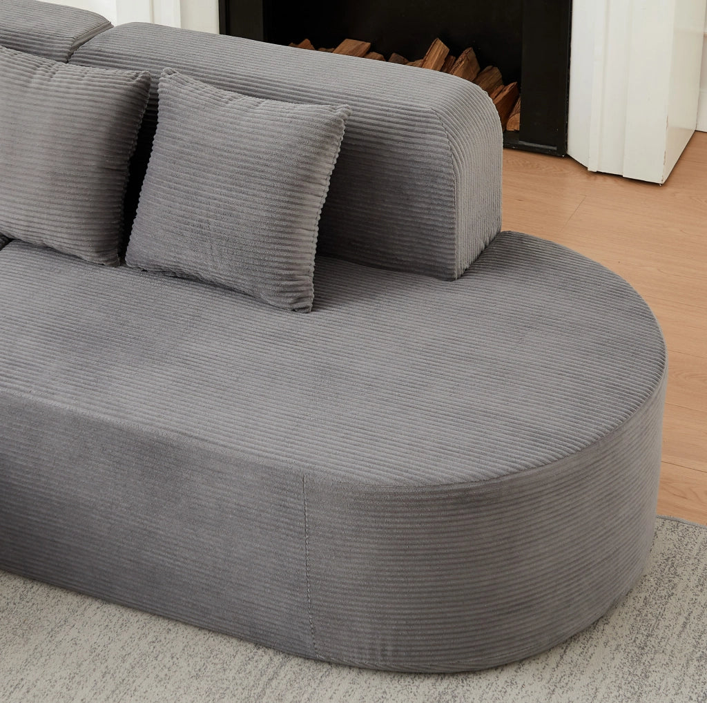 Divano modulare a L grigio in velluto a coste con forme curve