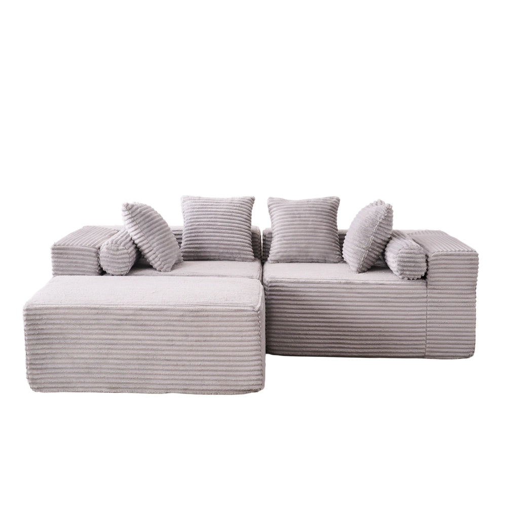 Divano modulare grigio a tre elementi con chaise longue