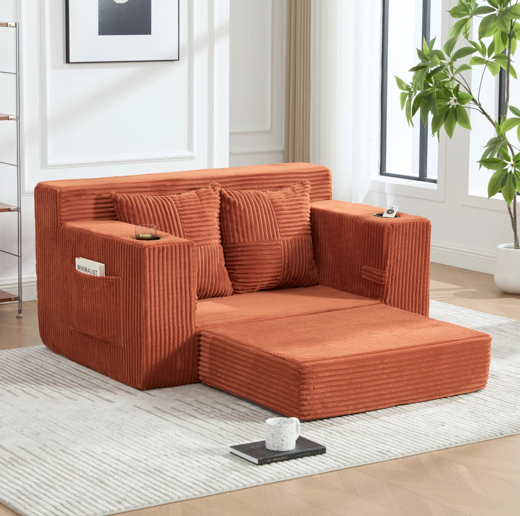 Divano arancione in velluto a coste con tasche laterali e due cuscini