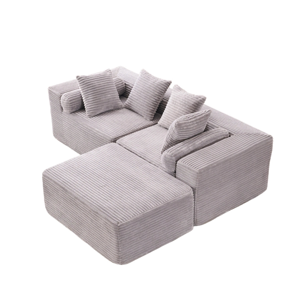 Divano modulare grigio a tre elementi con chaise longue