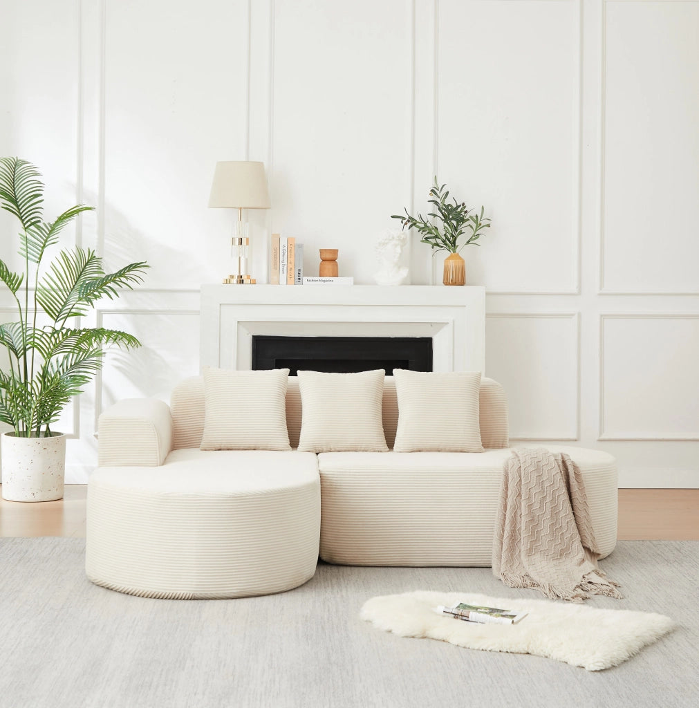 Divano modulare a L beige in velluto a coste con forme curve
