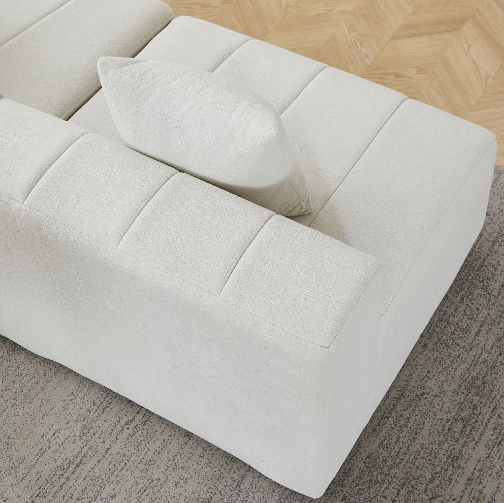 Divano modulare curvo in chenille beige con 2 cuscini