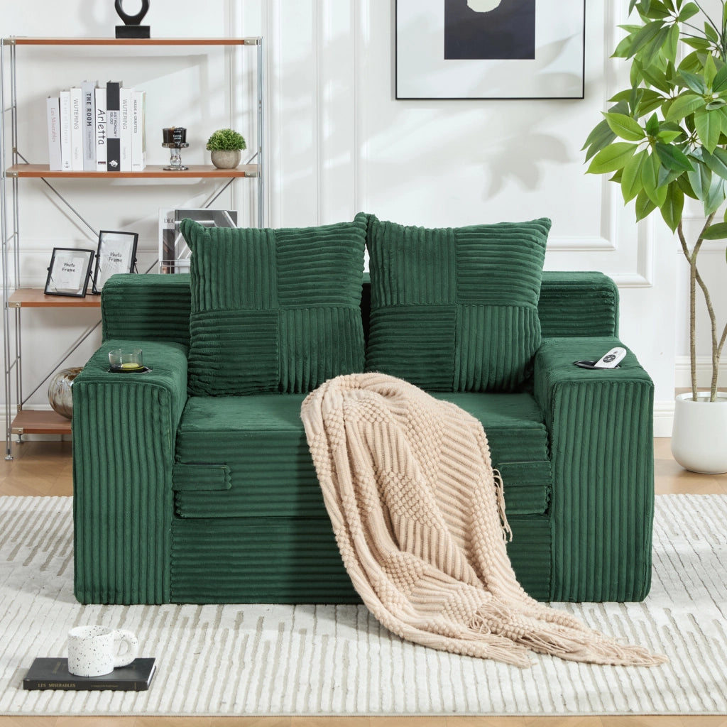 Divano pouf ULEVR 151x133x64 cm in velluto a coste verde smeraldo con 2 cuscini e tasche laterali