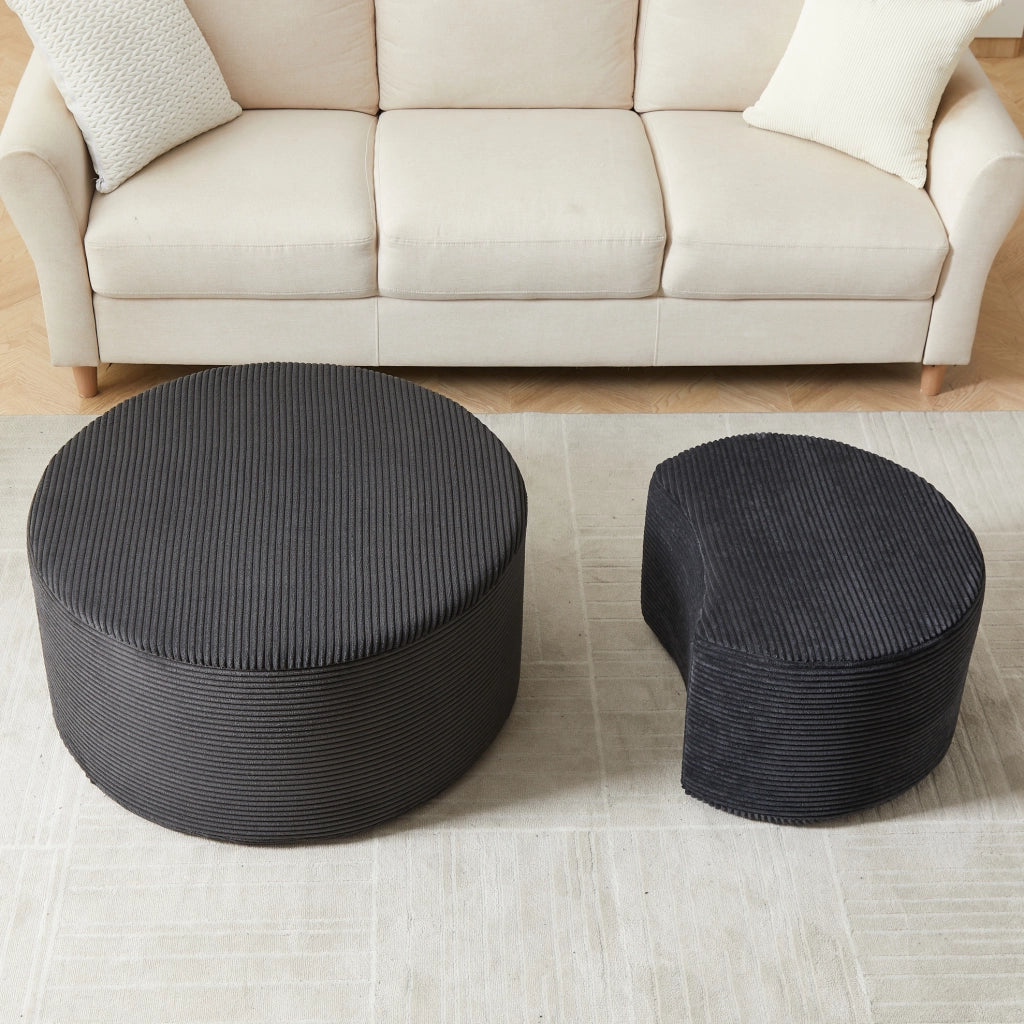 Set di 2 tavolini rotondi imbottiti in tessuto nero, utilizzabili come pouf