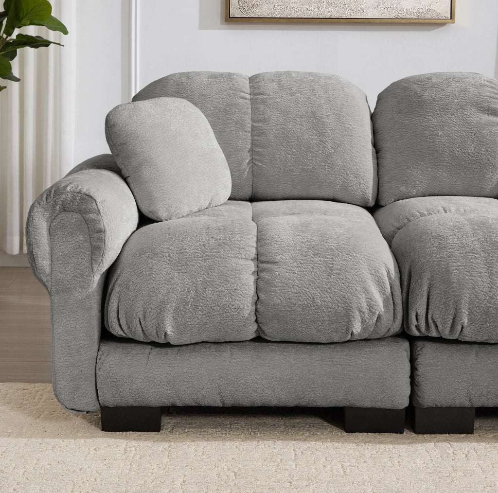 Divano angolare a L a 3 posti in tessuto chenille grigio chiaro con pouf mobile e 2 cuscini decorativi