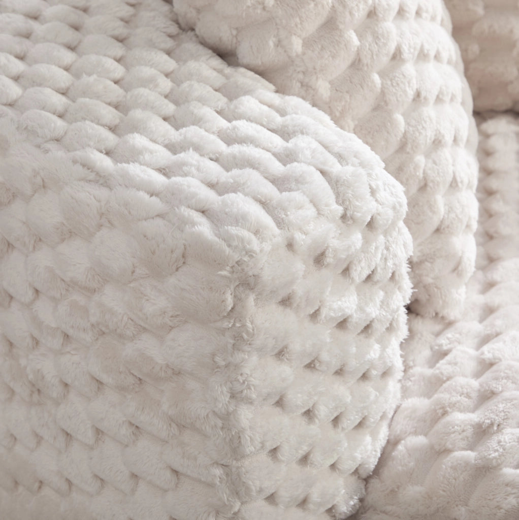 Poltrona compatta con pouf, design avvolgente e rivestimento in tessuto